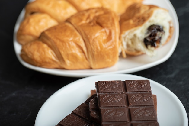 Croissants with chocolate filling on a dark surface.