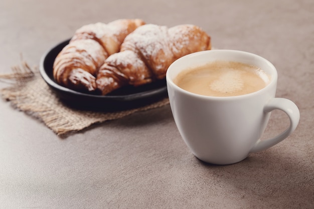 Croissants with coffee cup