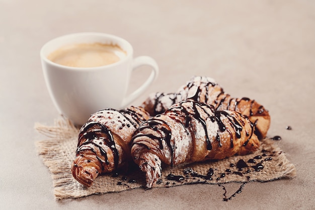 Croissants with coffee cup