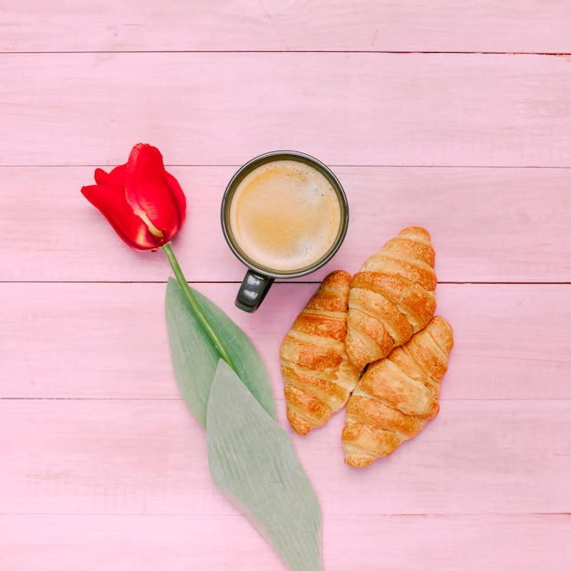 Free Photo croissants with coffee and tulip on table