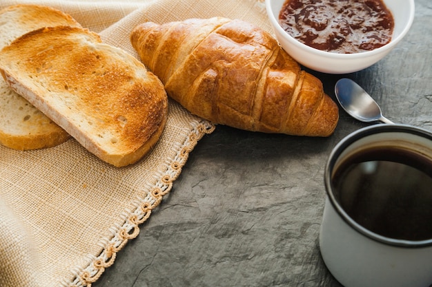 Free photo croissants with jam and coffee