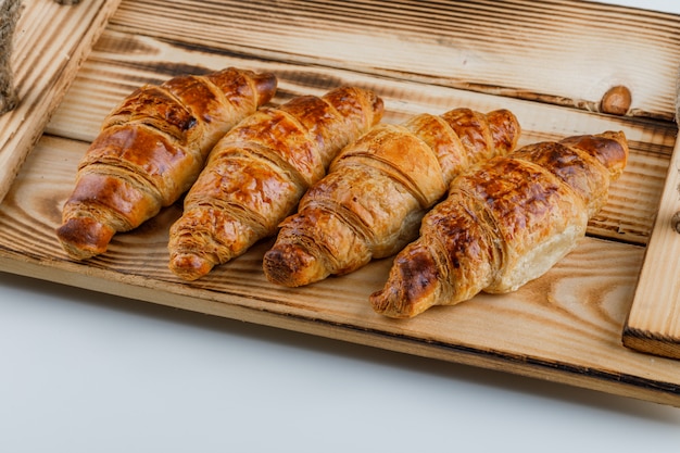 Free Photo croissants in a wooden tray.