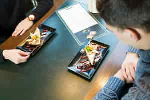 Free photo crom men enjoying dessert in cafe