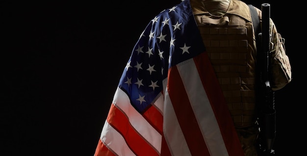 Crop of american soldier with flag and rifle