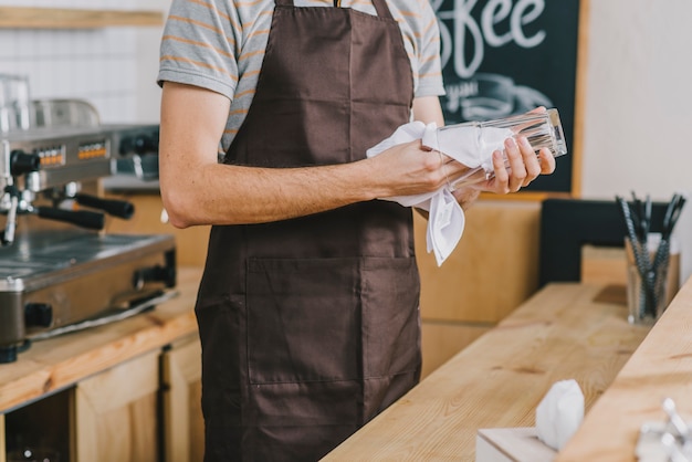 Free photo crop bartender drying glasses