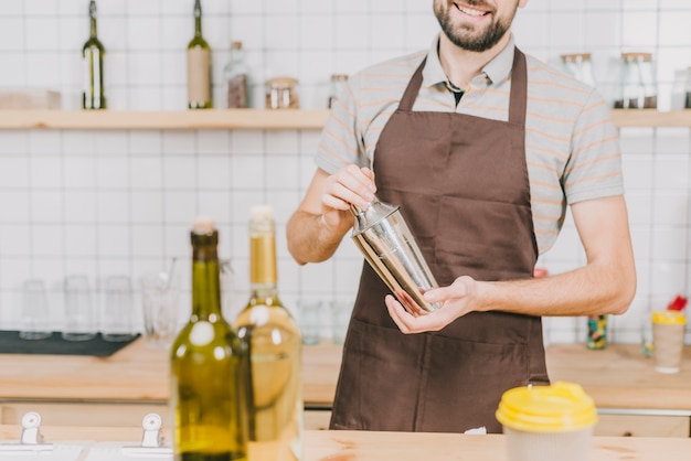 Crop bartender making cocktail