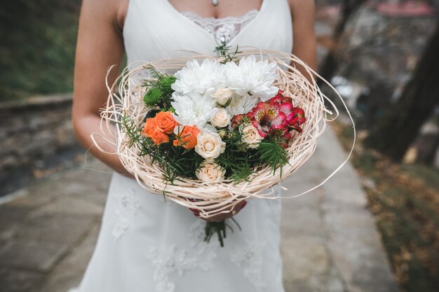 Free photo crop bride holding bouquet