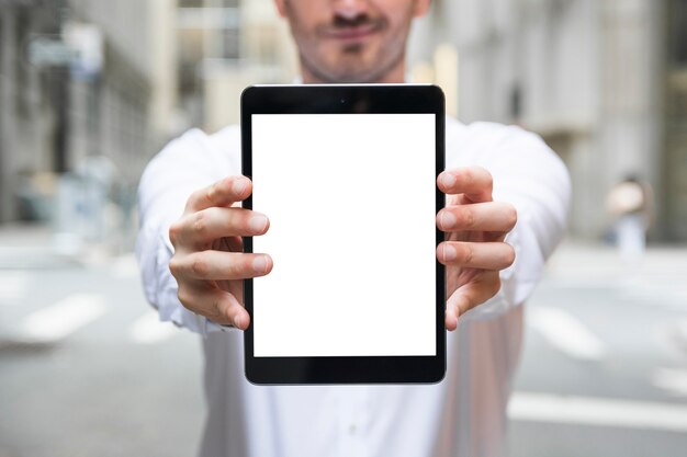 Crop businessman demonstrating tablet