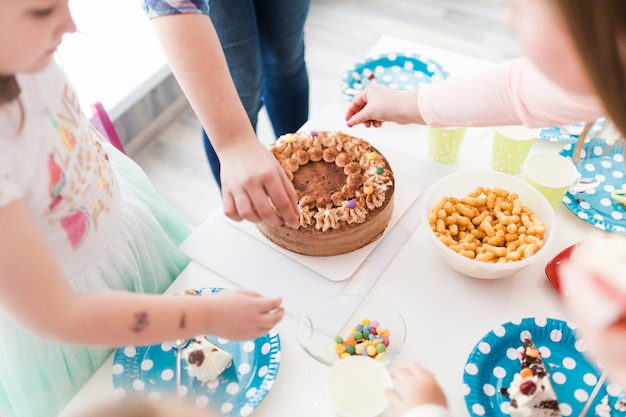 Free photo crop children decorating cake