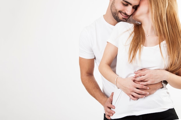 Crop couple cuddling on white background