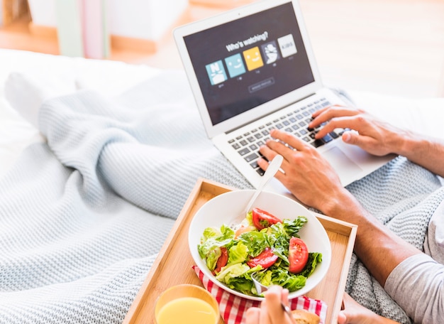 Free photo crop couple eating salad and choosing streaming service account