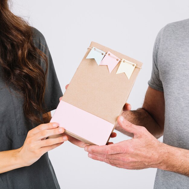 Crop daughter giving present to father