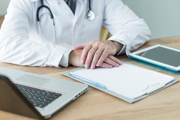 Crop doctor sitting near devices in office