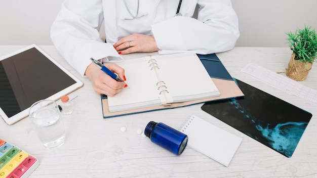 Crop doctor writing in notebook