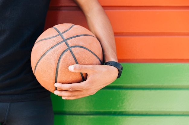 Free Photo crop ethnic man holding basketball