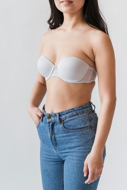 Crop of female in bra and jeans