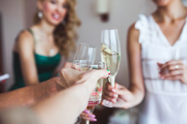 Crop female hands with wineglasses