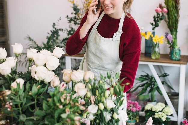 Crop florist speaking on smartphone