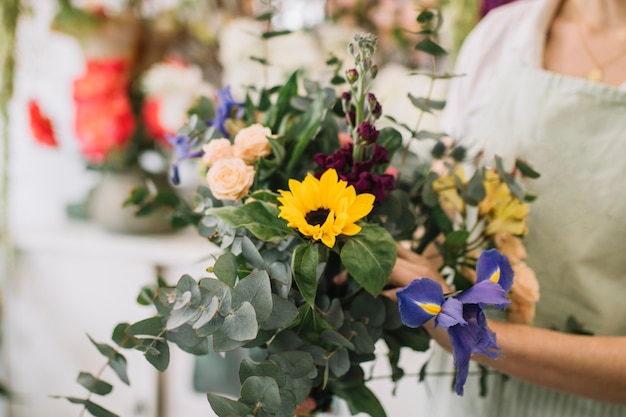 Crop florist with nice bouquet