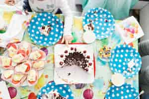 Free photo crop girl touching cake