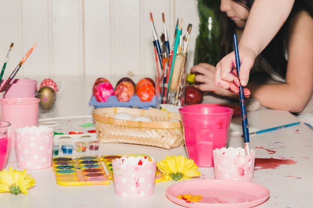 Free photo crop girls decorating eggs