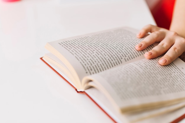 Crop hand holding book