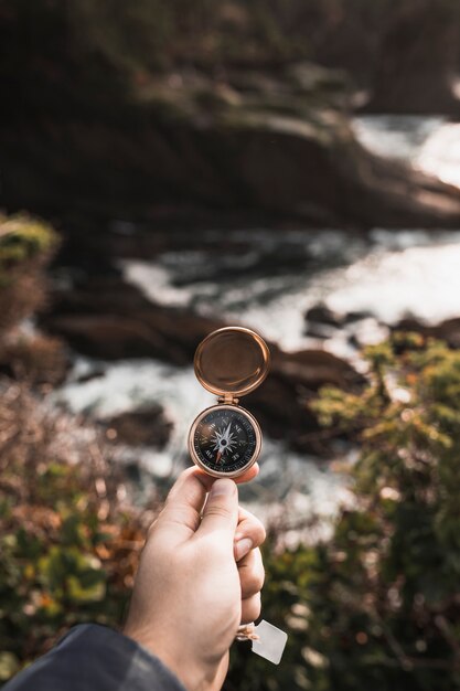 Crop hand holding retro compass