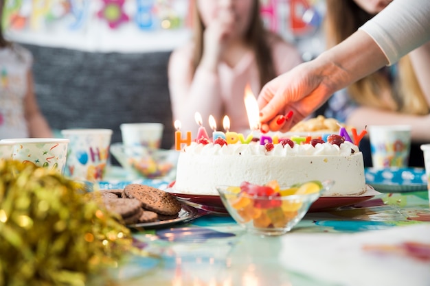 Crop hand lighting candles