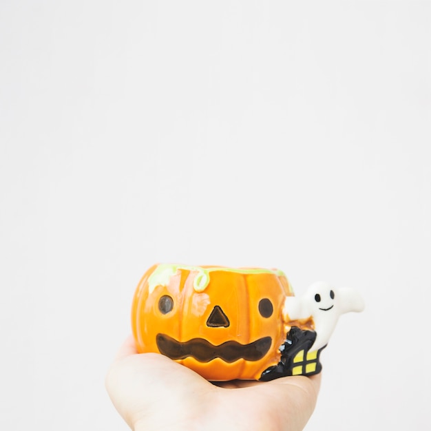 Crop hand with jack-o-lantern