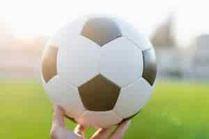 Free photo crop hand with soccer ball