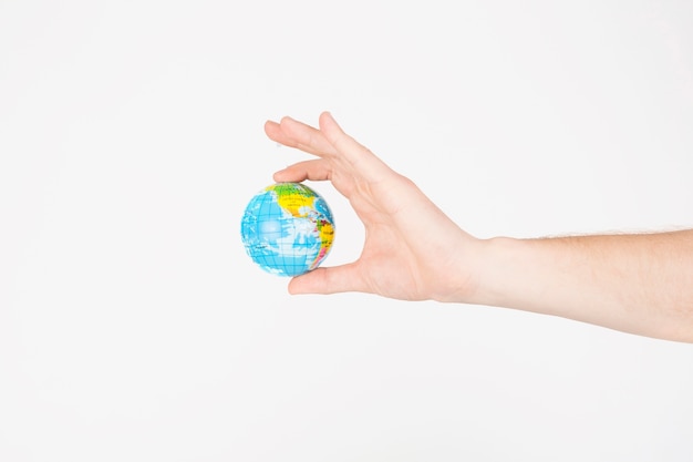 Free photo crop hands holding little globe