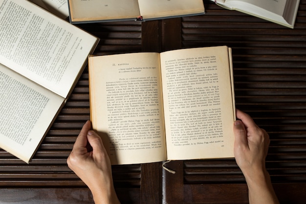 Crop hands holding opened book