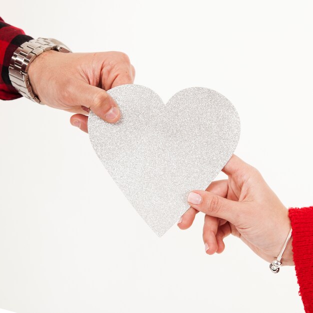 Crop hands holding paper heart