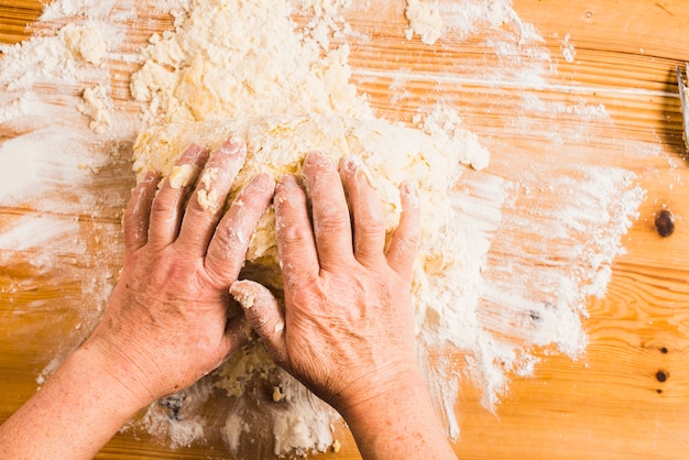 Free photo crop hands kneading dough