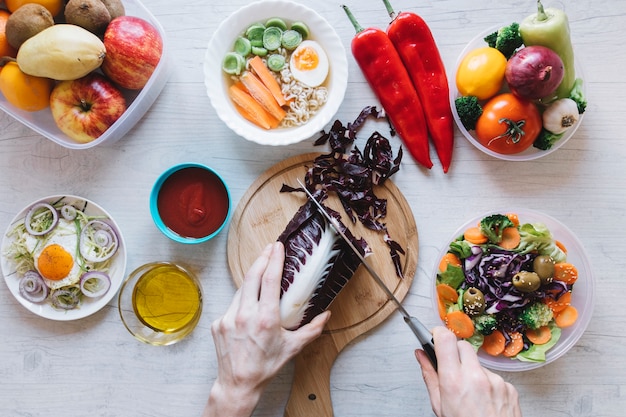 Crop hands making salad