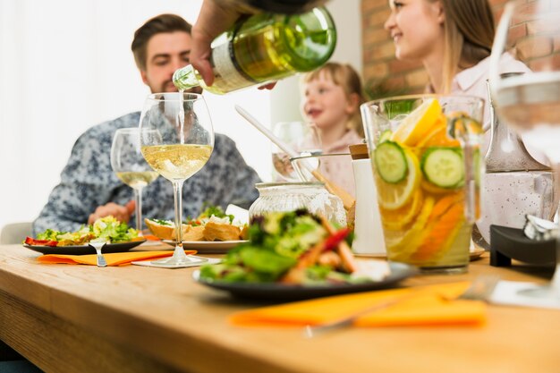 Crop hands of man pouring wine