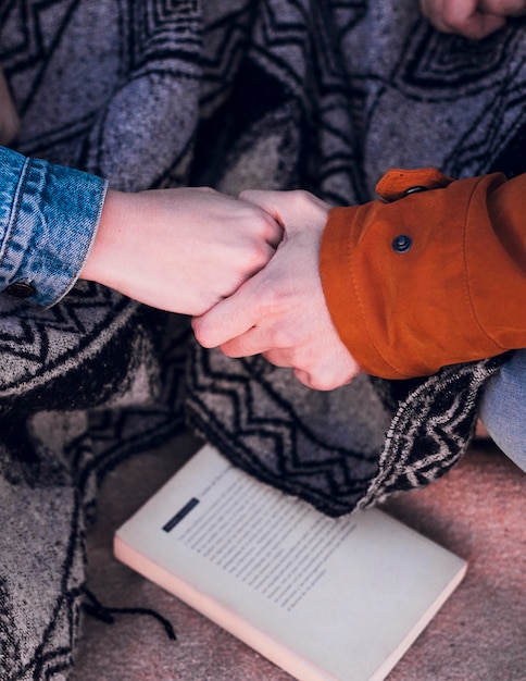 Free Photo crop hands near book