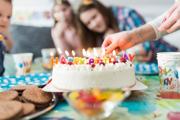 Free photo crop hands near cake with candles