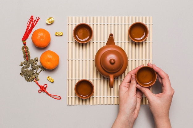 Crop hands taking cup from napkin