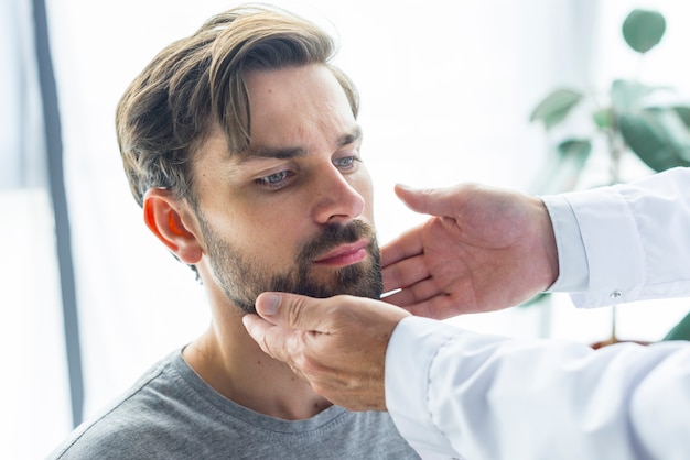 Free photo crop hands touching lymph nodes of patient