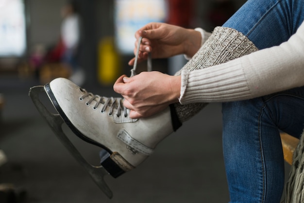 Free photo crop hands tying laces on ice skates