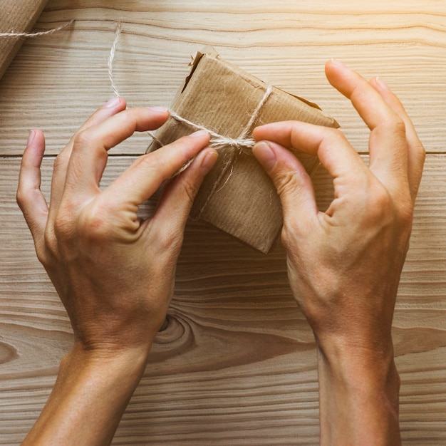 Free Photo crop hands tying present