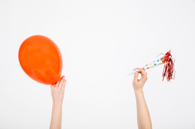 Free Photo crop hands with balloon and party horn