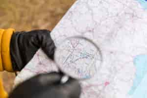 Free photo crop hands with magnifying glass reading map