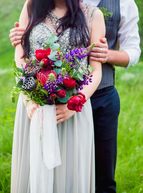 The crop image of romantic couple with flowers