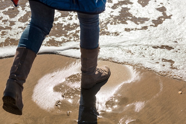 Free photo crop legs stepping into sea