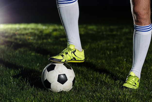 Free photo crop legs stepping on soccer ball