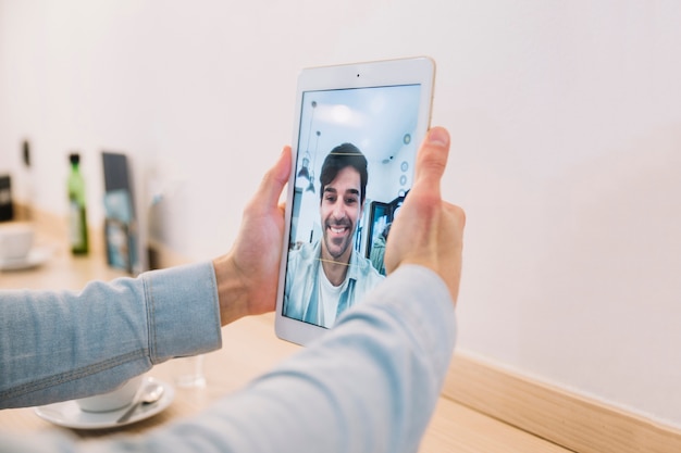 Crop male hands taking selfie with tablet