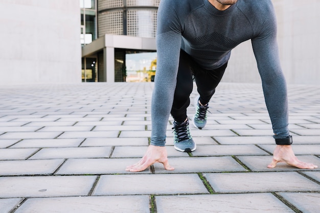 Crop man doing plank exercise