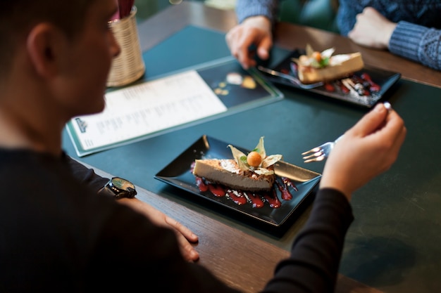 Free Photo crop man eating dessert in cafe